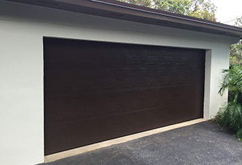 Outdated brown paneled garage door prior to new installation in Keller, Texas