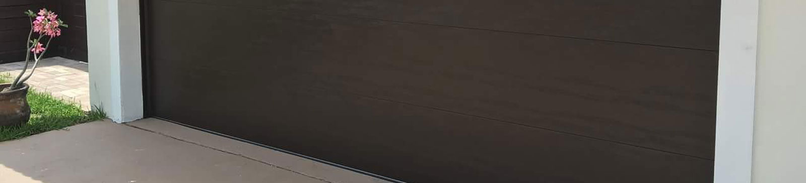 Outdated brown paneled garage door prior to new installation in Keller, Texas