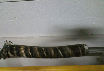 Broken torsion spring visible on sectional garage door in Colleyville home