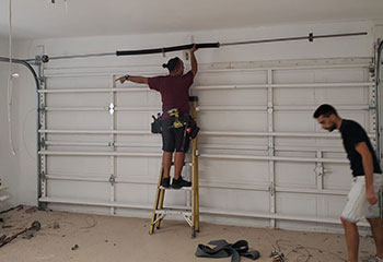 Garage door repair experts assembling LiftMaster opener in a Colleyville home garage