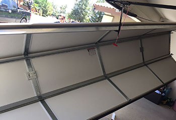 Old garage door misaligned before new sectional installation in Colleyville home