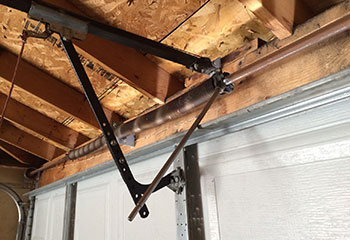 Expert technician installing replacement lift cables on residential garage door